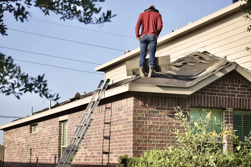 Professional roofer working on a residential roof in Coral Gables